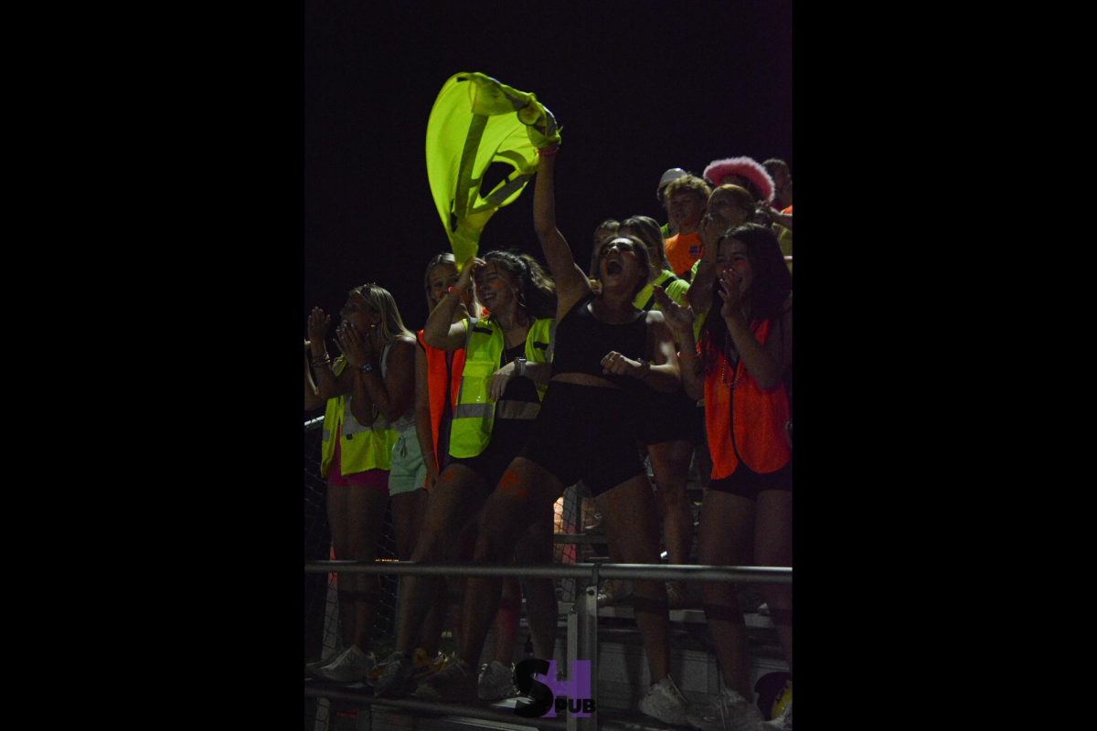 Jolee Castro, 12, swings their vest around after the Broncos scored the winning touchdown to extend their season record to 3-0 Sept. 20.