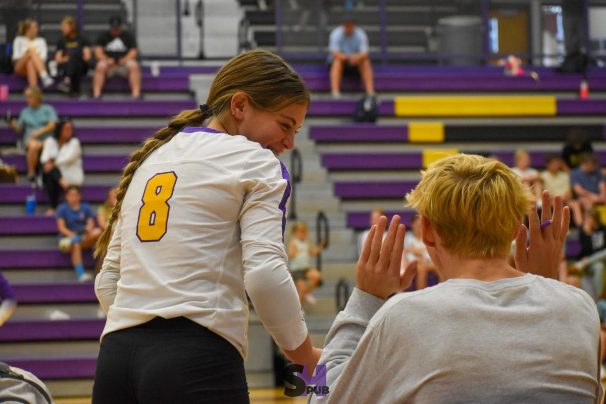 On Sept. 9, Haedyn Lynnes, 9, and Miles Pankey, 12, joke around on the sideline of a home varsity volleyball dual.