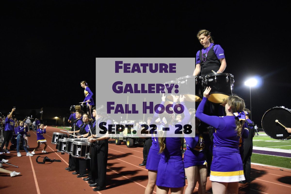 On Sept. 27, Audrey Schoenig, 11, and Layla Donovan, 10, play a cadence after the coronation ceremony. This was the first time either of them had been hoisted by cheerleaders to play.