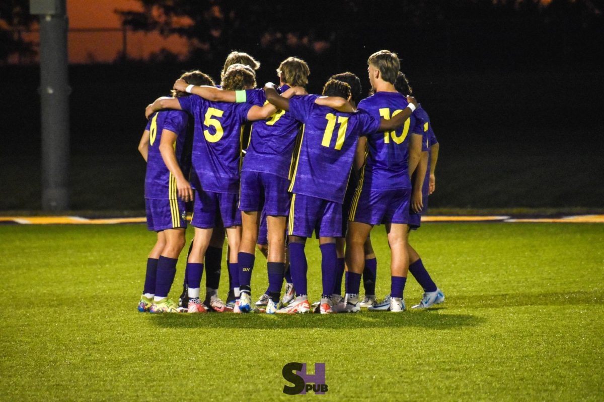 On Oct. 2, the varsity soccer team huddles before their game against Blue Valley West.