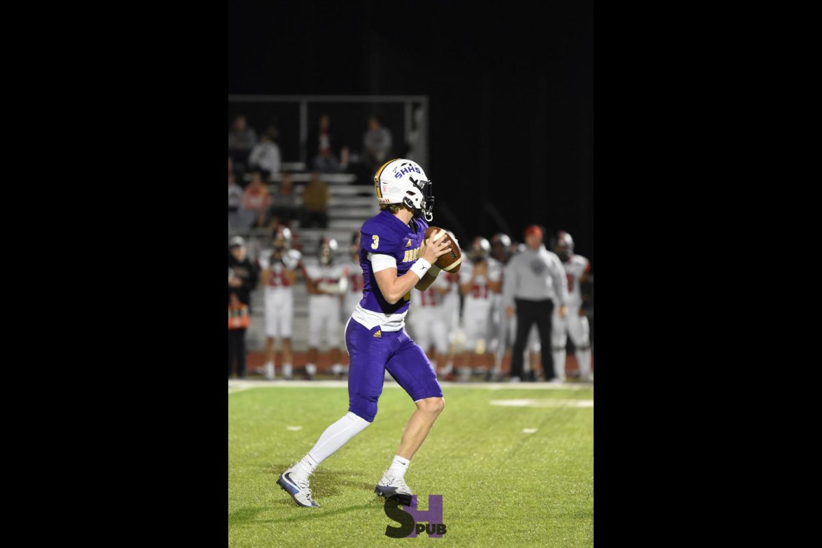 Jordan Miller, 11, prepares to throw a pass in the second half of a home football game against the Emporia Spartans Oct. 18.