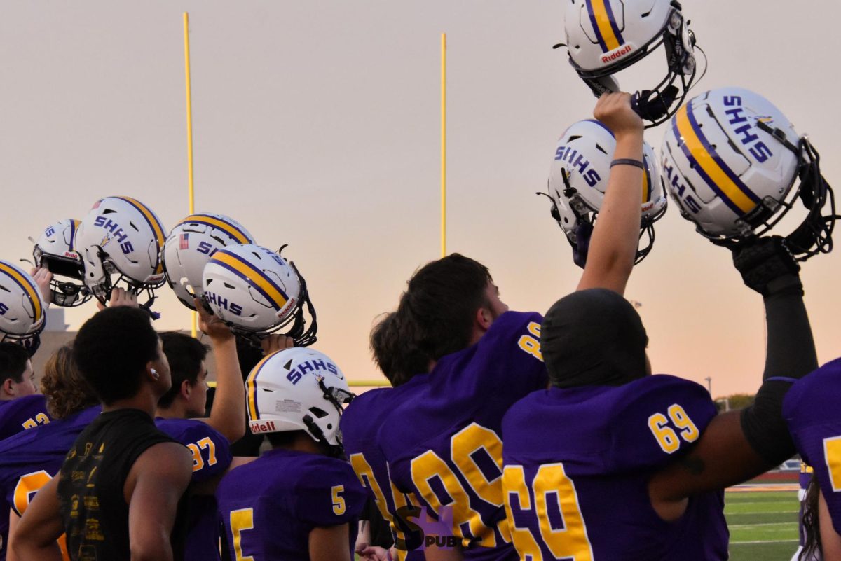 Members of the varsity football team wait for kickoff at the start of the homecoming game Sept. 27.