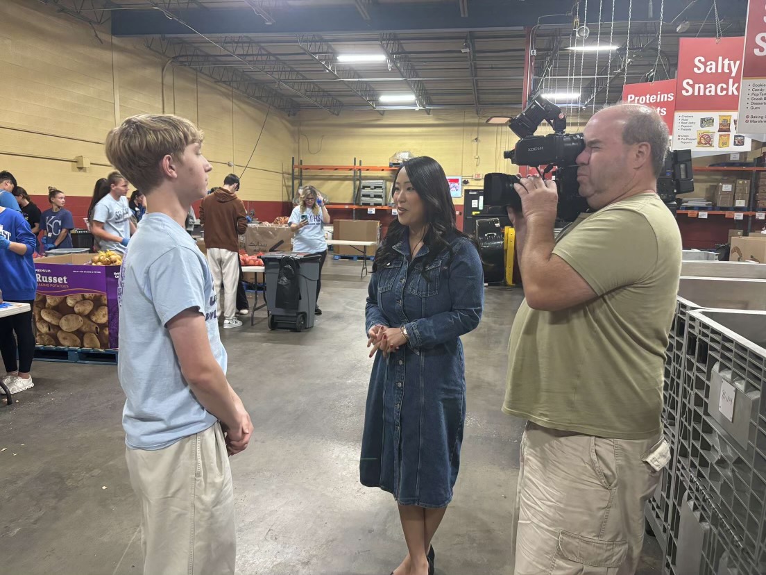 Reporters from KSHB 41 interview Heinen as a part of a television segment covering the volunteer club's trip. Heinen, along with two other club members, Evan Brown, 12, and Logan Beckman, 12, organized the trip.