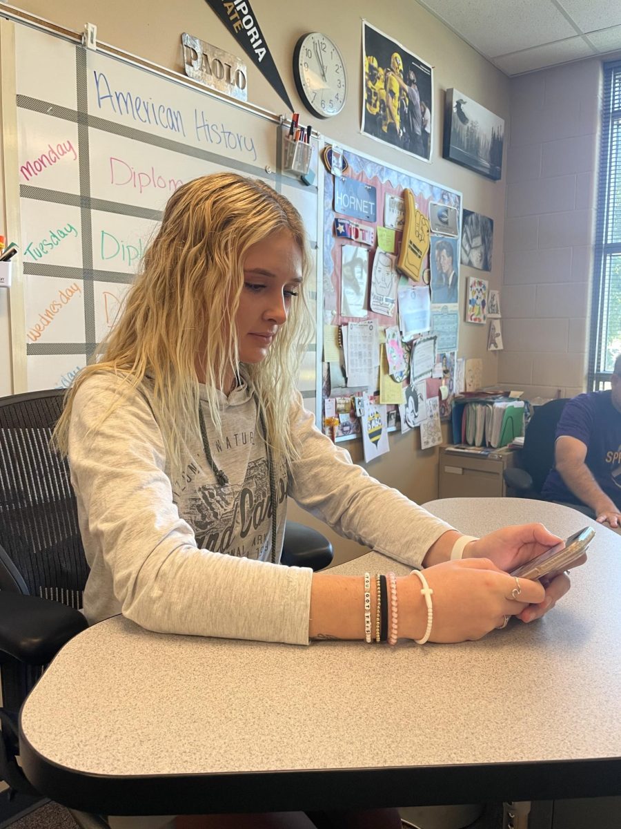 Lily Boden, 12, on her phone during class. Some teachers are less strict about the phone pockets, so students are able to have more freedom. (Photo by M. Chaulk) 