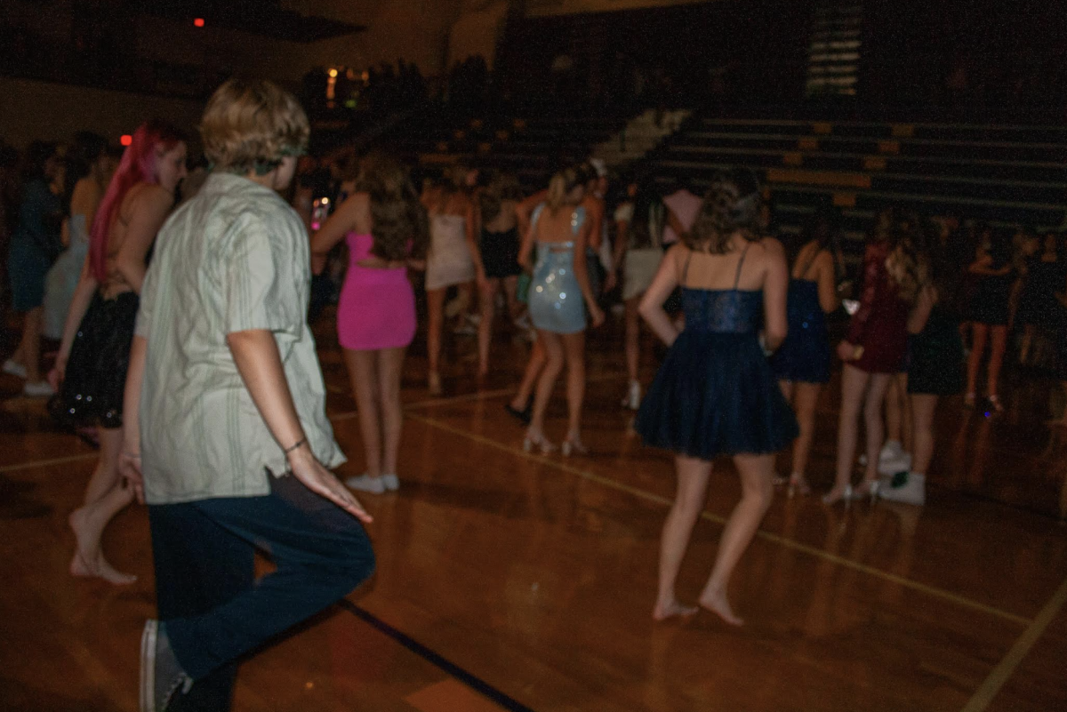 Caption: Students dance to the classic song Footloose. Other line dance songs, like the Cupid Shuffle, were played on homecoming night. (Photo by O. Melius)