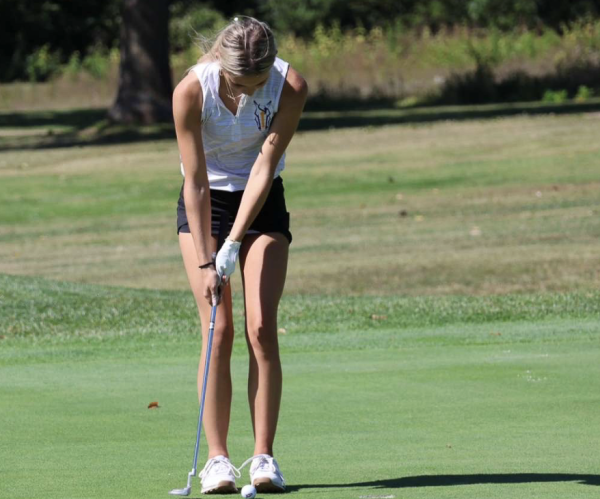 Kinsley Miller, 10, putts her ball into the hole. This was taken at one of Miller's first ever golf meets. (Photo Provided by K. Miller) 