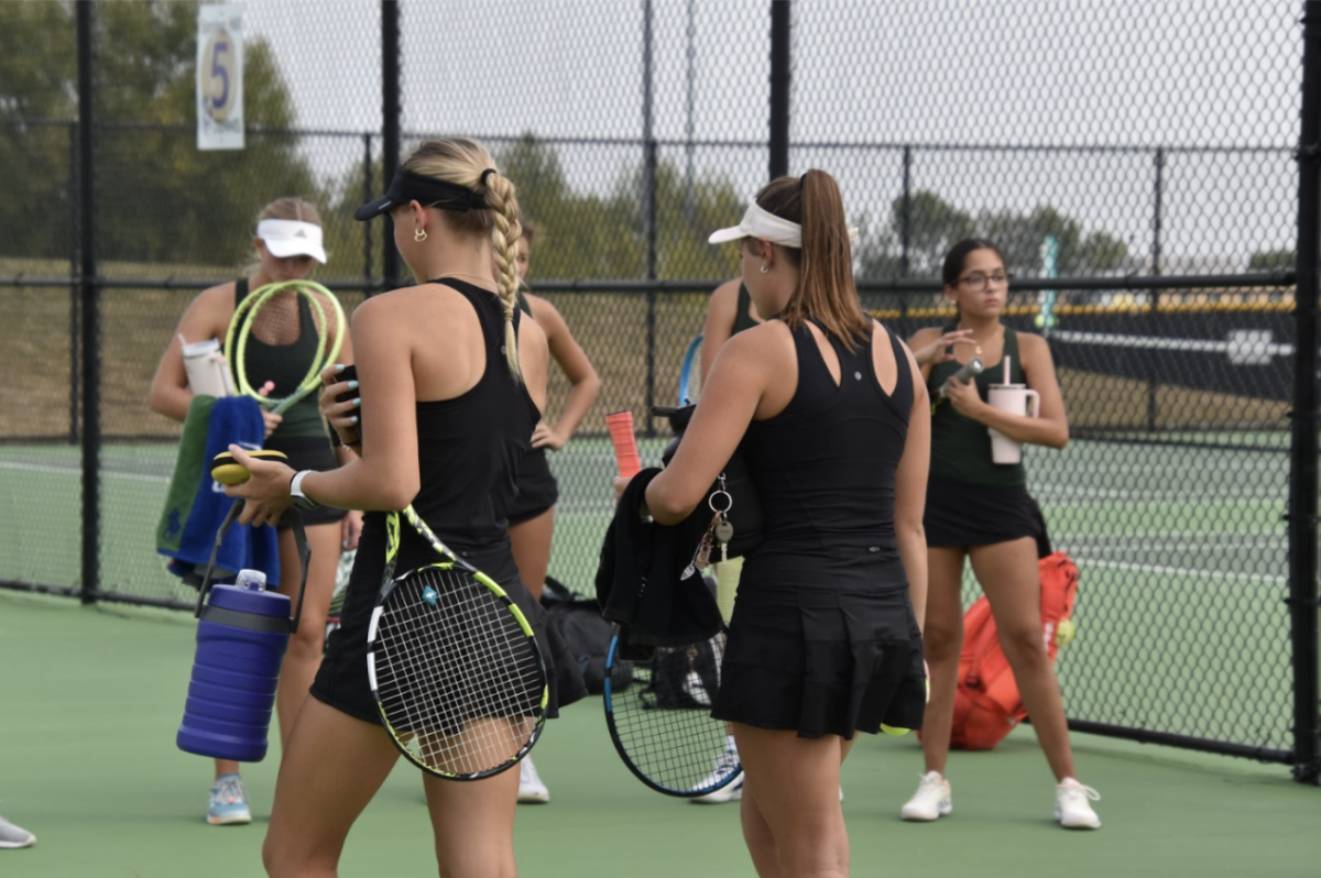 Ashley Anderson, 11, and Brynna Pierson, 12, walk together in between matches. Anderson and Pierson are doubles partners making it important to communicate. (Photo by A. Gulbrandson) 