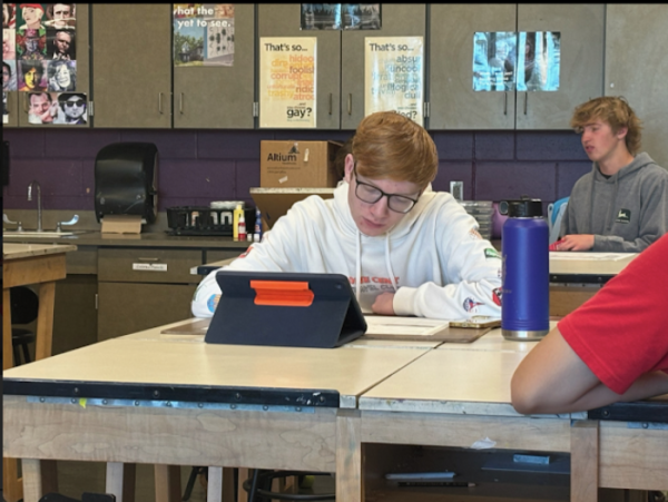 Blake Bunker, 12, works on a drawing project for their class. This is a new project they have started. (Photo by M. Ingle)