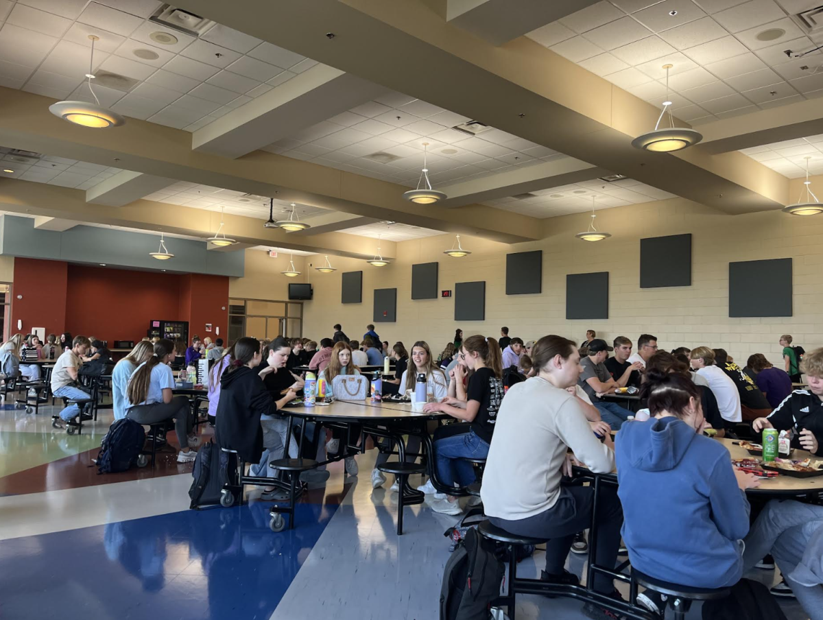 Students sit at the lunch tables and eat. It's important to be considerate of others because it's difficult to know what they may be going through. (Photo by M. Marmon)