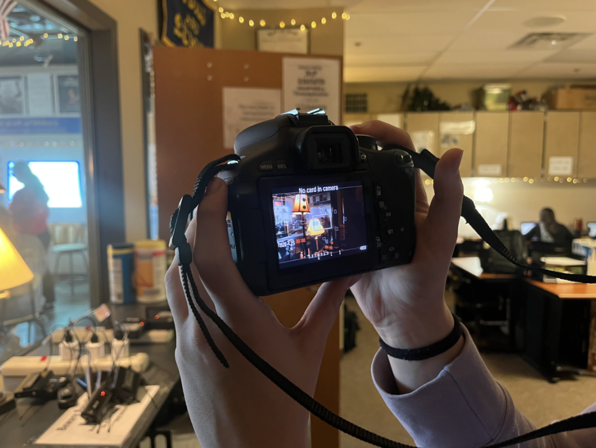 A student holds a Canon camera that video production students use. Video students also work with more equipment that include lav, tiny mics, and shotgun. (Photo by M. Marmon) 