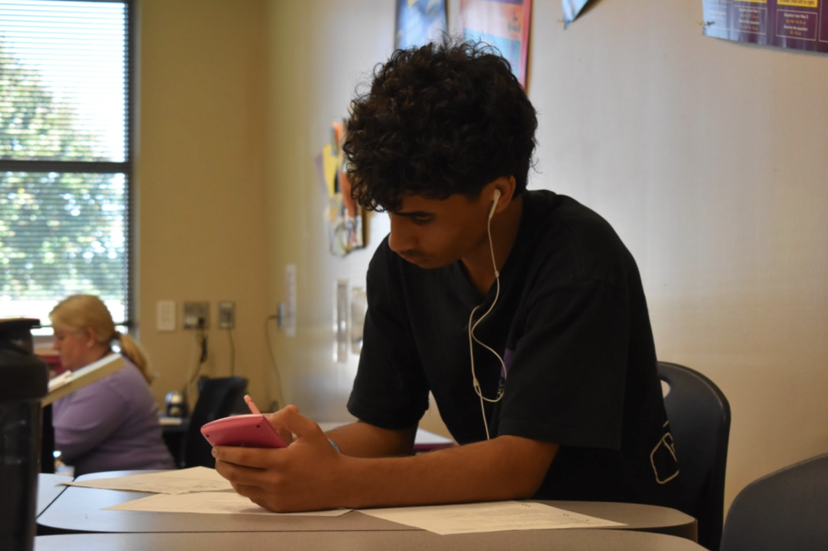 Ammar Aljishi, 12, works independently during their fourth hour Algebra II class. Individuals set their own bar of what a perfect student means to them. (Photo by K. Tran)