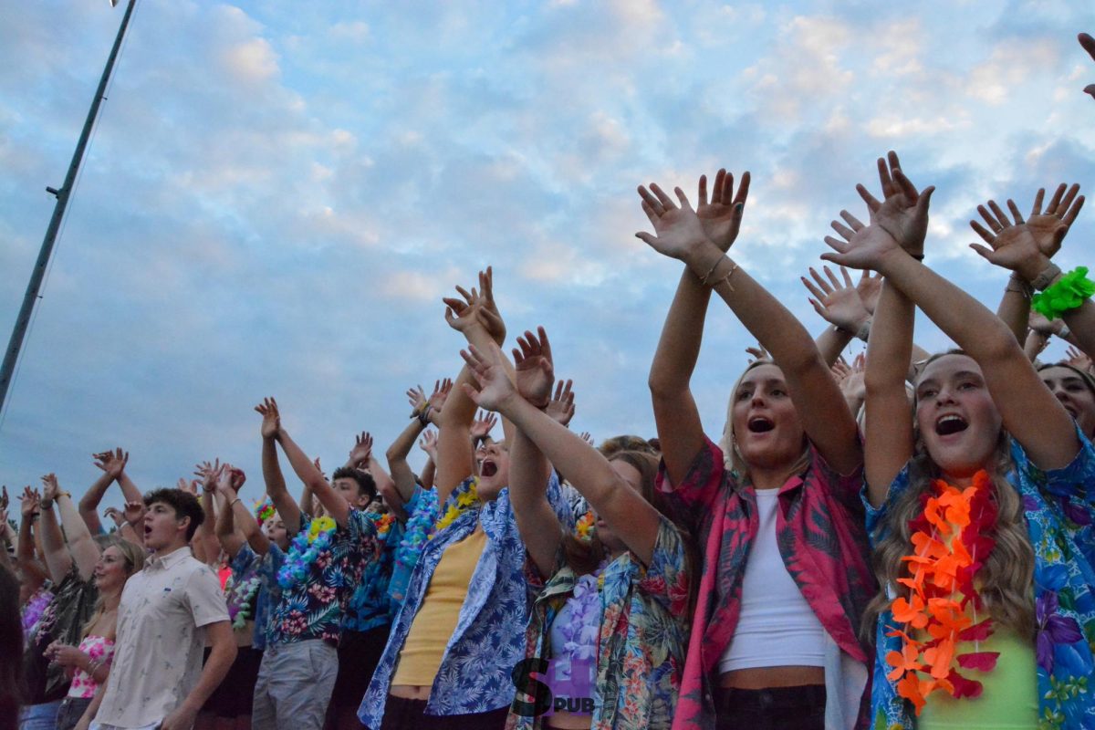 Members of the student section, who dressed up to fit the Hawaiian theme, put their hands together for kickoff Sept. 6.