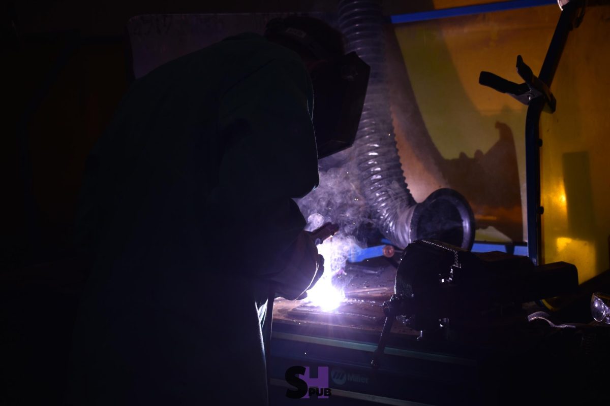 Franklin Gardner, 12, welds a frame for a metal chair Oct. 31.