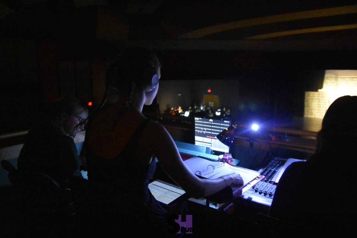 On Nov. 11, Addelyn Horne, 12, assisted by Layla Blattel and Jocelyn Satchell, 11, call out cues from the booth Nov. 11.