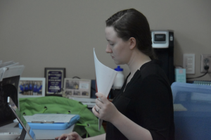 Alison Koesser, English teacher, looks over their students’ assignments. Teachers have many tasks to complete on a daily basis which may play a factor in the “perfectionist” mindset. (Photo by M. Marmon) 