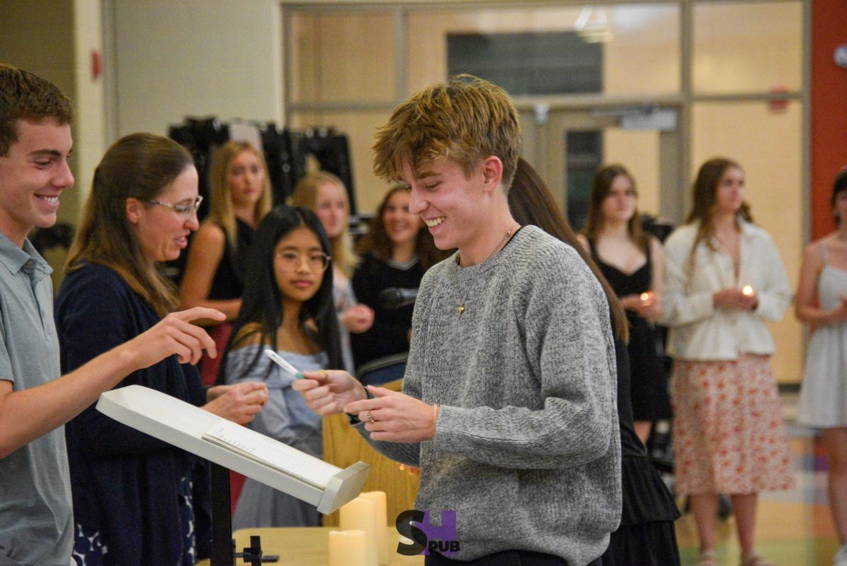 Dylan Estes, 11, and Logan Beckman, 12, laugh together during the NHS induction ceremony Nov. 13.