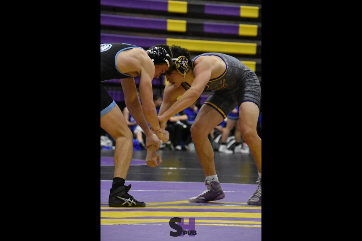 On Dec. 6, Brodie Pipkin wrestles against an opponent from Shawnee Mission East at the Broncos’ home tournament.