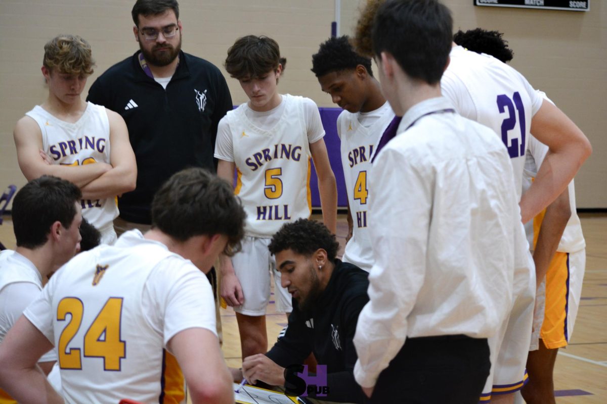 Luke Jennings, assistant coach, instructs members of the boys’ c-team during a game against Olathe East Dec. 9.