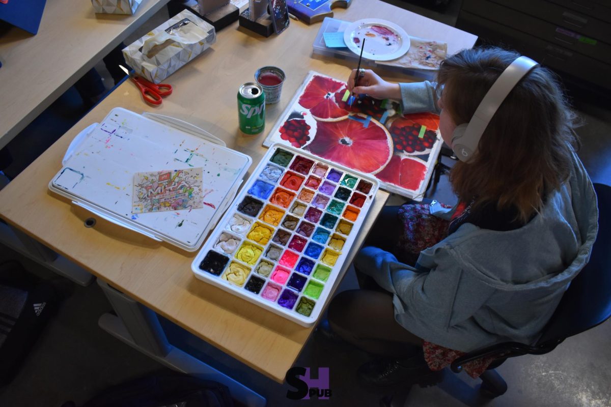 MJ Bailey, 12, applies delicate brush strokes to a watercolor painting Dec. 11.