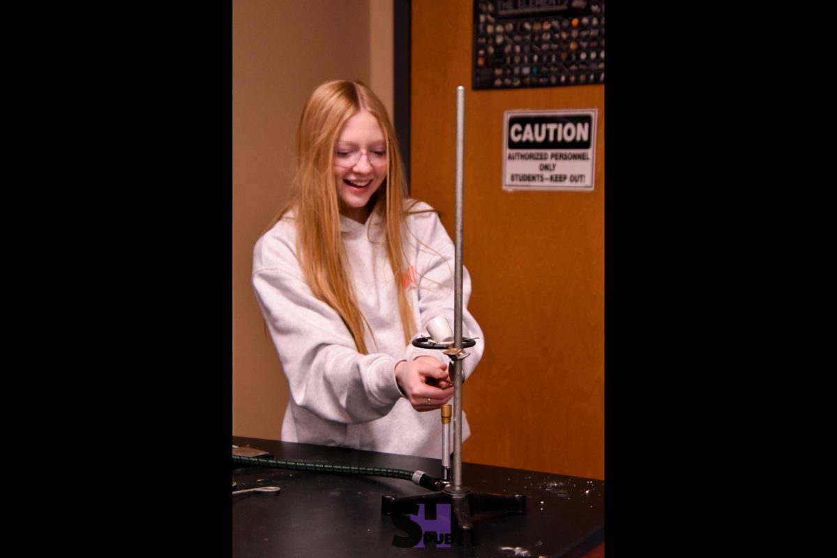 On Nov. 21, Lily Bunker, 10, lights a bunsen burner during a lab that compares molecular and empirical formulas.