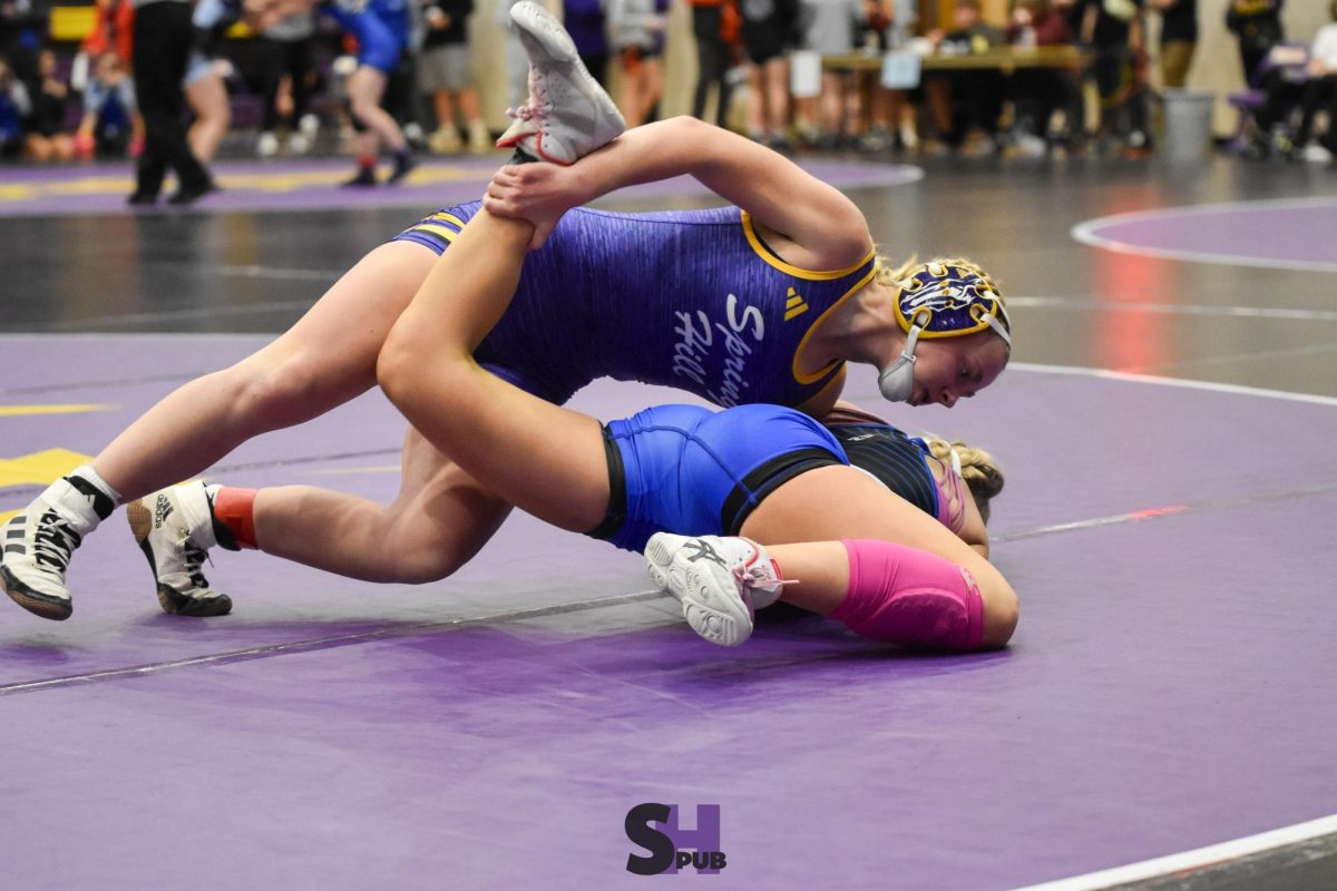 Elliana Ruffin, 12, pins an opponent from Washburn Rural Dec. 7.