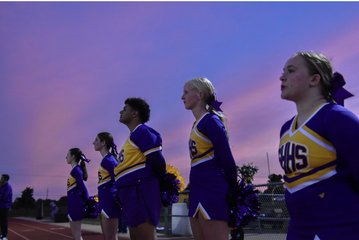 Junior cheerleaders stand together during the homecoming football game. The juniors are the captains on the team and call the cheers for others. (Photo by O. Tarvin) 