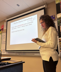 Gissel McDonald, AP chemistry teacher, teaches a lesson on intermolecular forces. In addition to teaching chemistry, McDonald is an instructional coach for other educators (Photo by D. Estes)