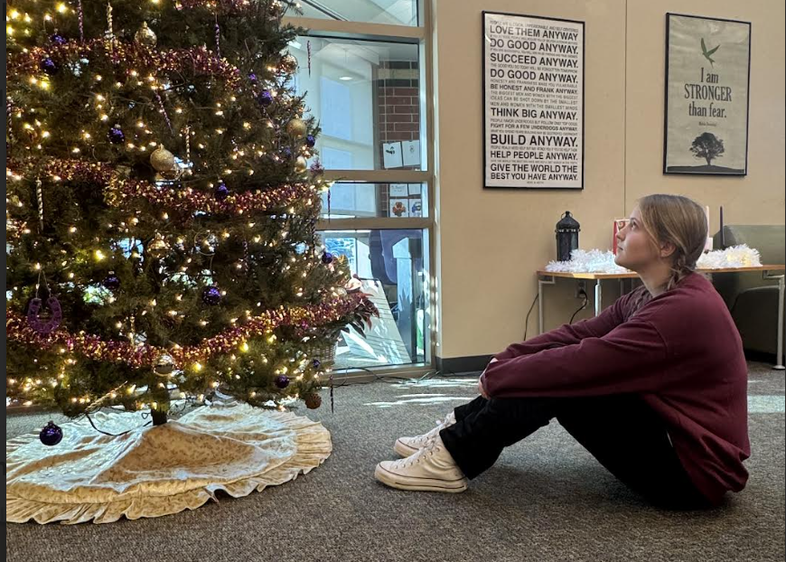 Mallory Marmon, 11, looks up at a Christmas tree. They consider what has changed within Christmas spirit. (Photo by P. Creach)