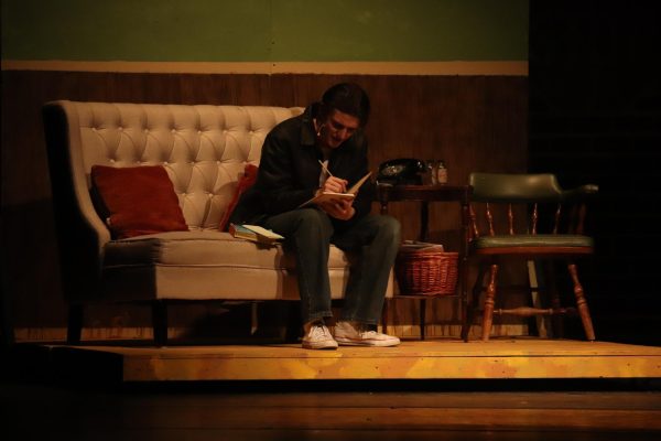 Andon Mattox, 12, preforms as Ponyboy Curtis in the high schools performance of The Outsiders. This scene is at the end of the performance when Ponyboy reads the letter left by Johnny. (Photo by M. Brown)