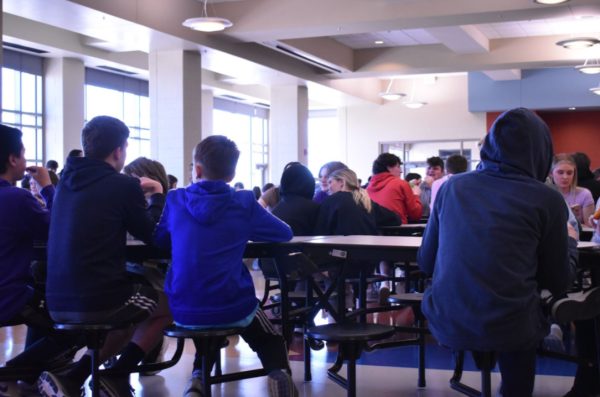 Students eat during second lunch, conversing with those around them. Unlike the benches at the middle schools, the high school’s lunch tables provide gaps between each seat, which allow for more personal space for each individual. (Photo by M. Chaulk)