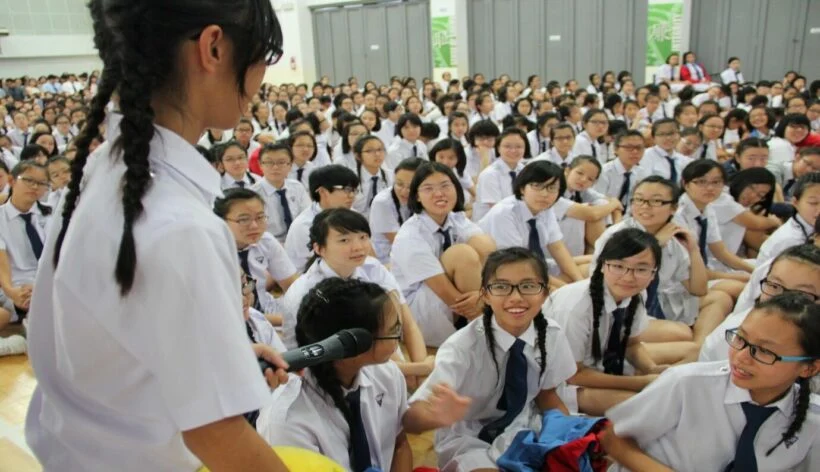 Students in Thailand gathered on their school grounds. Throughout the female student body, there is an obvious trend in their hairstyles. (Photo by Thaiger)