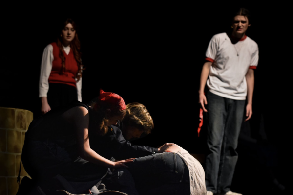 Ponyboy Curtis, portrayed by Andon Mattox, has a flashback with Cherry Valance, portrayed by Nora Ide, 12, to when the greasers find Johnny, played by Zach Vasser, 12, after he was jumped by the Socs. This flashback showed the first time that Johnny was jumped by the Socs (Photo by D. Estes). 