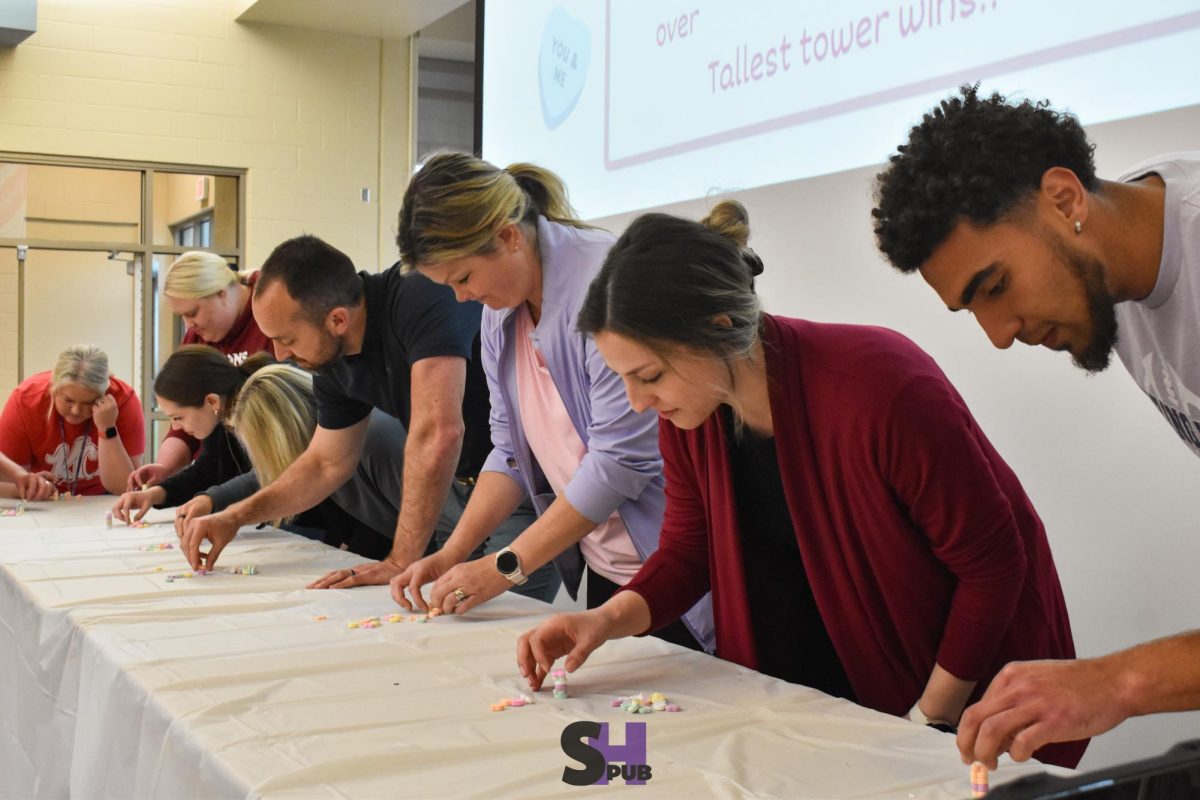 On April 18, several teachers represent their department in a Sweethearts candy stacking contest. 