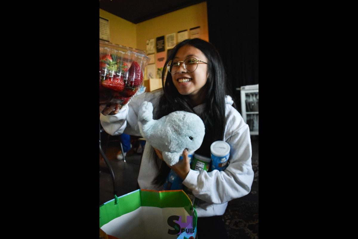 On April 22, Kayley Tran, 11, clutches gifts during a SPUB gift exchange.