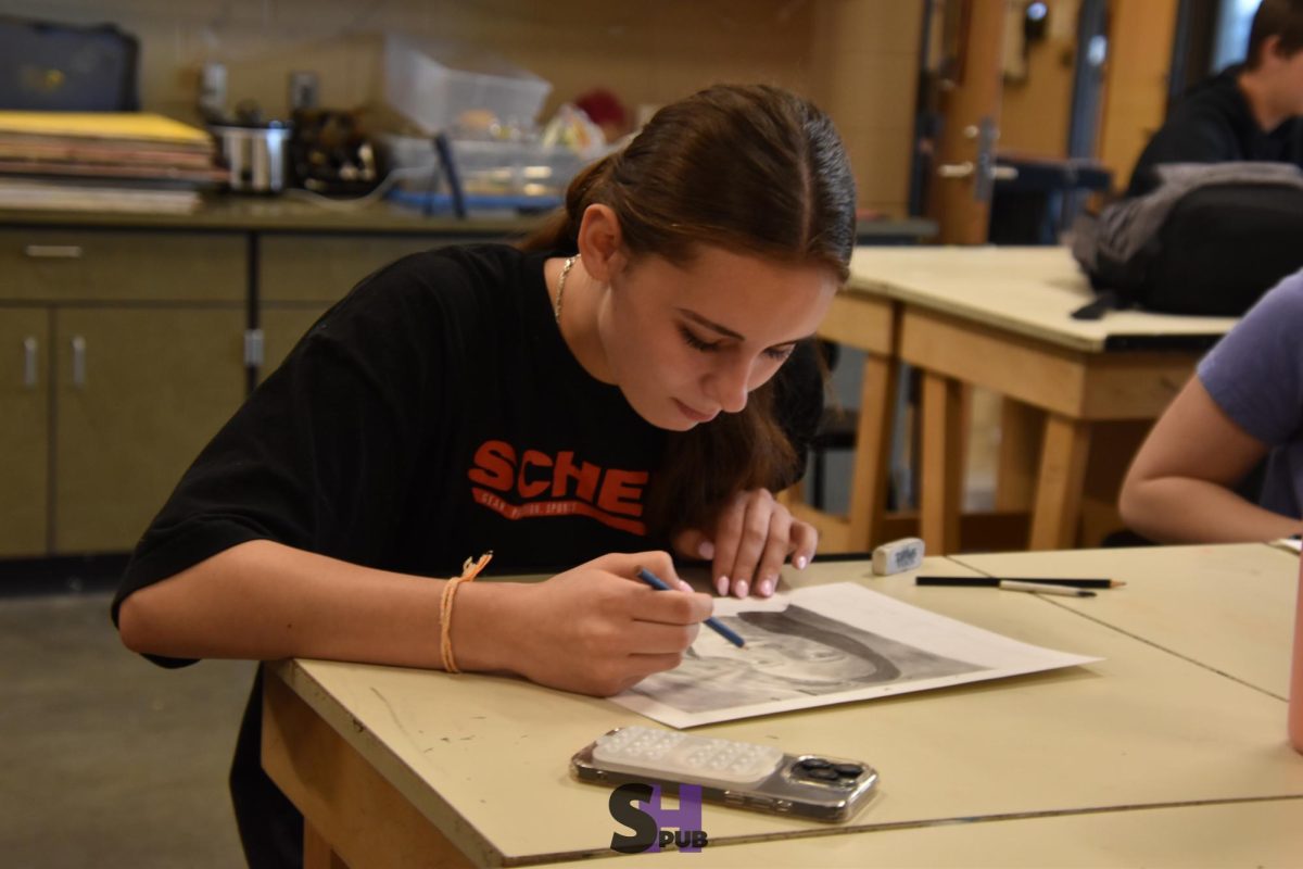 Piper Feiss, 9, works on their self portrait in art fundamentals April 17. 