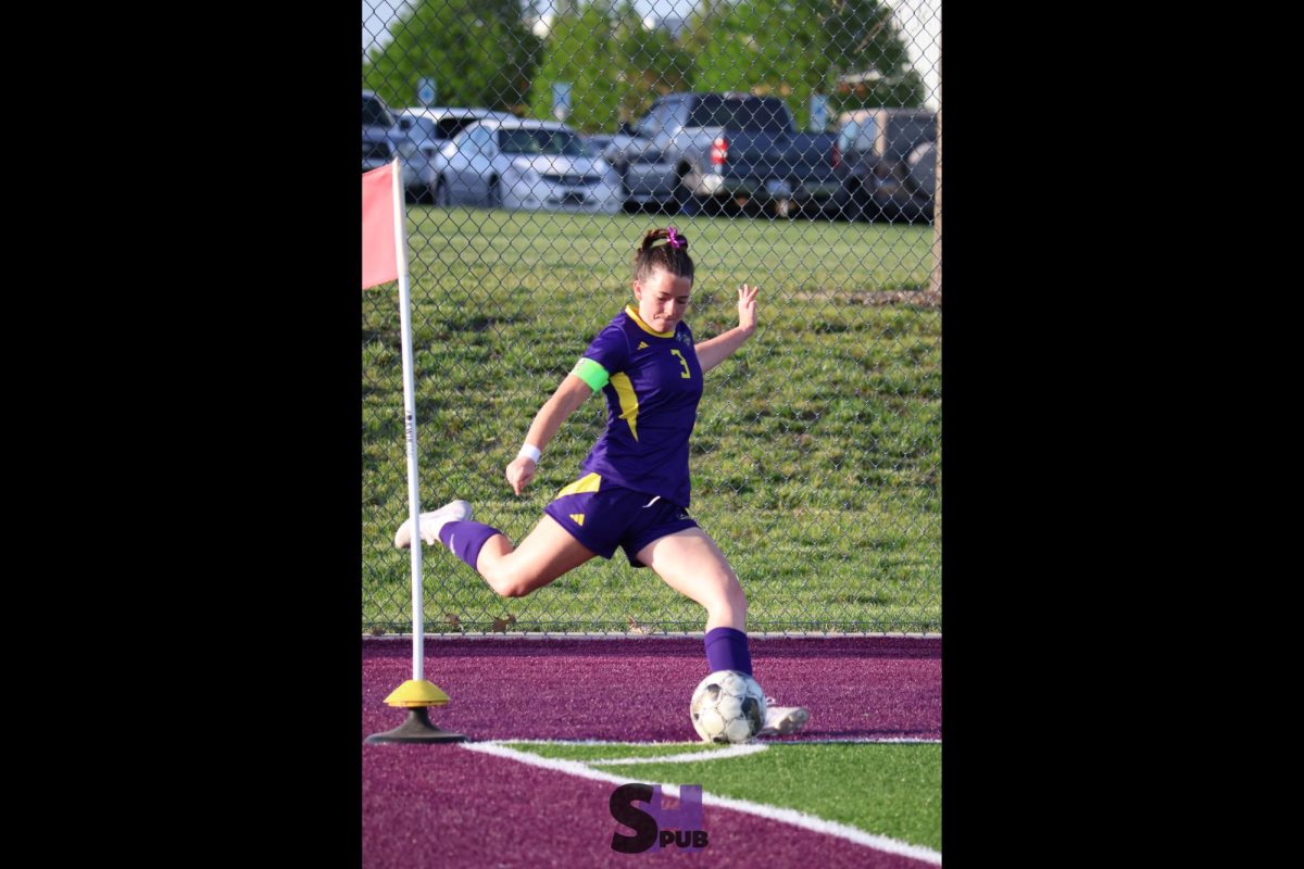 On April 22, Elizabeth Williams, 12, corner kicks during a varsity soccer game.