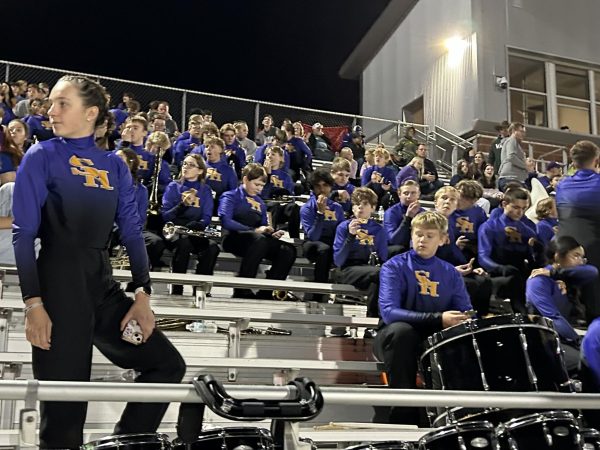 The high school band takes a pause after their playing. Alongside debuting their halftime performance, they also kept the student section lively with music. 