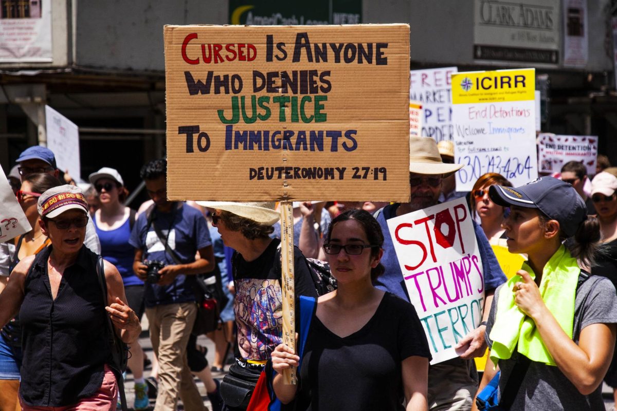 A woman protests immigration raids in Chicago during President Trump's first term.
