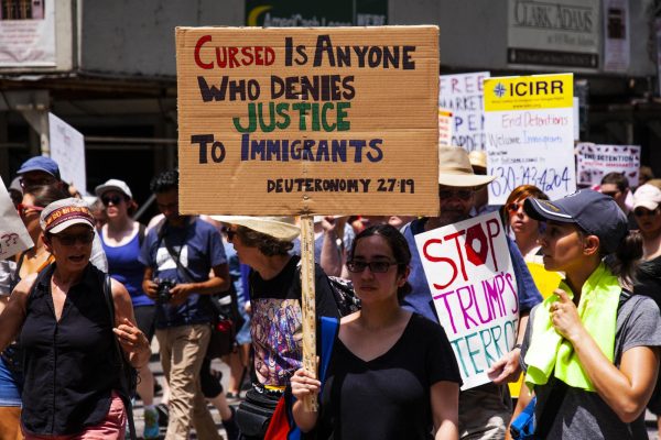 A woman protests immigration raids in Chicago during President Trump's first term.
