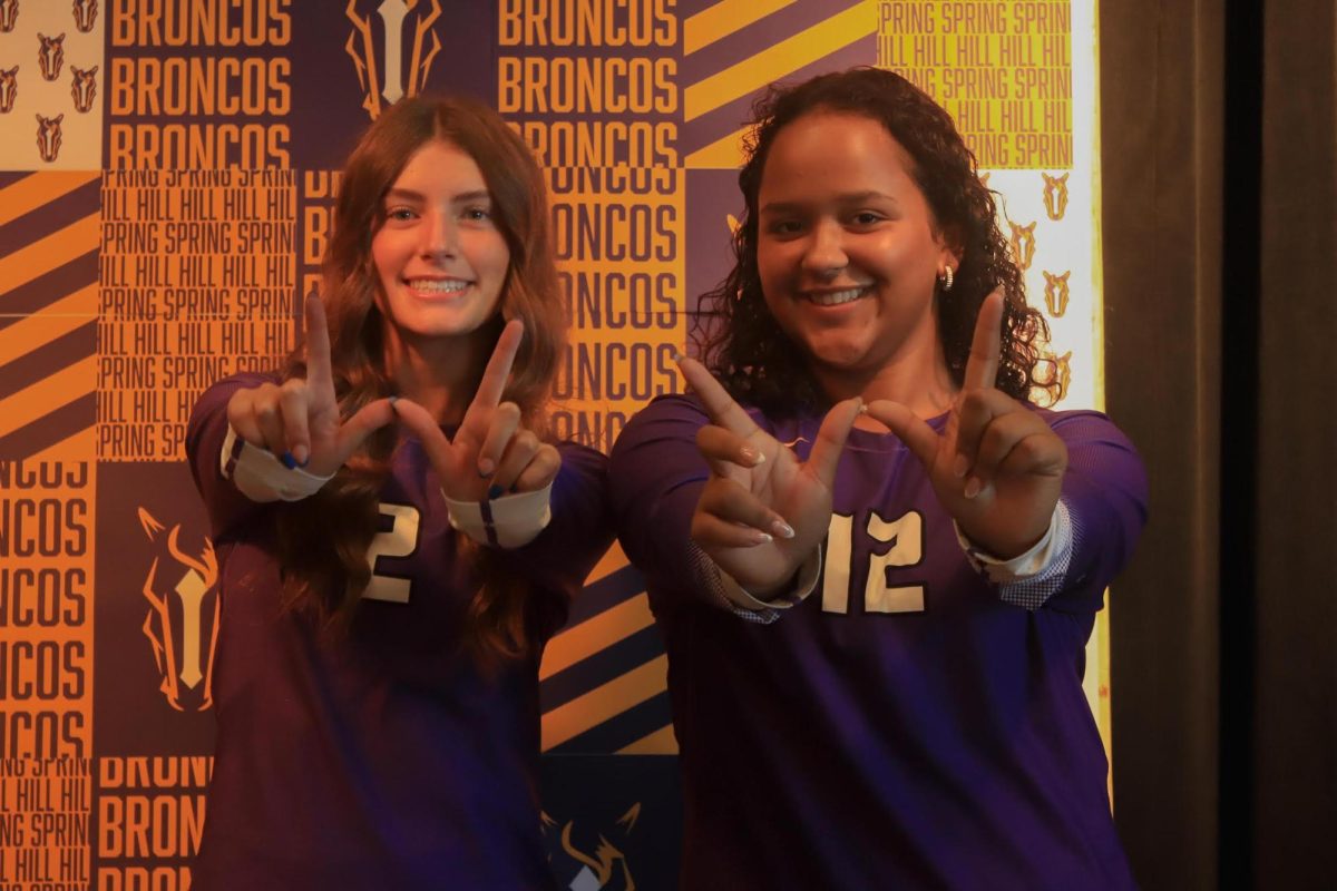 Ainsley Aten and Kaliyah Phifer, 11, posing for a photo on media day. This season, the high school's Varsity Girl's Volleyball team has ten players.