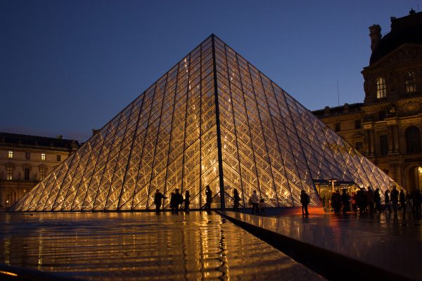 The Louvre is centrally located in Paris, France. It is famous for its pyramid structure at the main entrance and its countless significant artifacts and artworks.