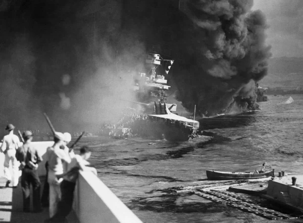 Soldiers watch as the USS California burns. This occurred shortly after the attack on Pearl Harbor. 