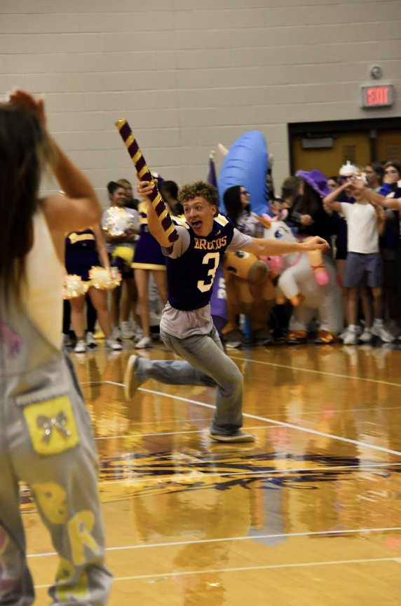 Jordan Miller, 12, running through the gym with the Spirit Stick. The Class of 2026 has won this stick for two consecutive years, this year marking their last.