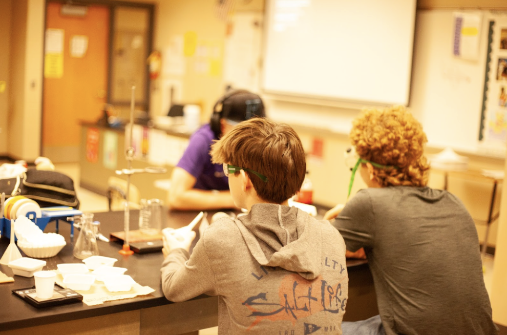 Walking through one of their first Chemistry labs, the students are paying close attention. With the use of hot plates and [Taylor] Harrison repeating the importance of safety glasses, their attention is hooked. (Photo by Harper Pluid)