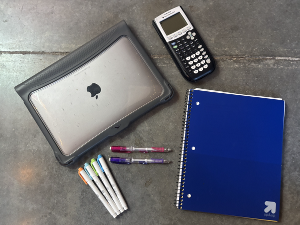 Various school supplies are displayed. Academic pressure is one challenge that students may face. 