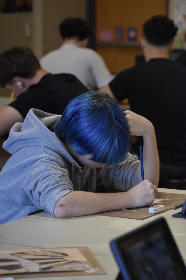 Molly Duncan, 9, works on an art project. In addition to clothes, dyed hair was another way students expressed themselves.