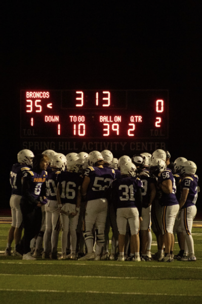 Durbin captures the excitement on the sidelines during a Friday night football game. For them, sports photography is all about finding the story behind the lens.