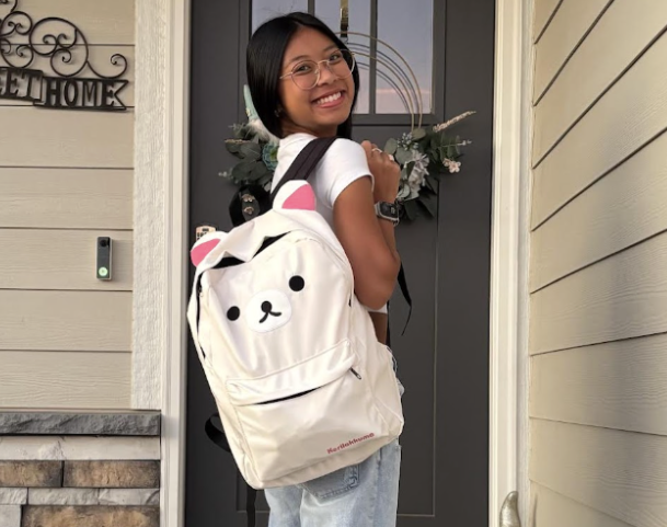Tran poses for their parents on the first day of senior year. They take pictures on the first day of every year they have been in school.