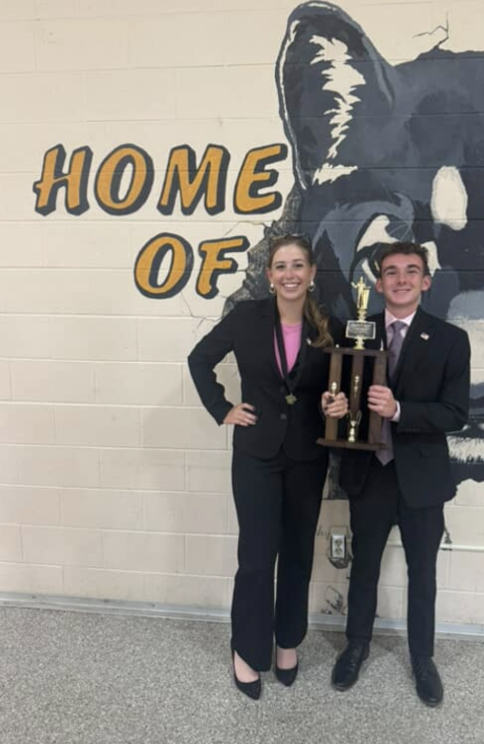 Kailey Howell, 12, and Jackson Roberts pose with their trophy after taking first place at a tournament in Paola on Oct 4, 2025. Both national-level competitors, their win reflects the skill and teamwork they’ve developed through years of debate.
