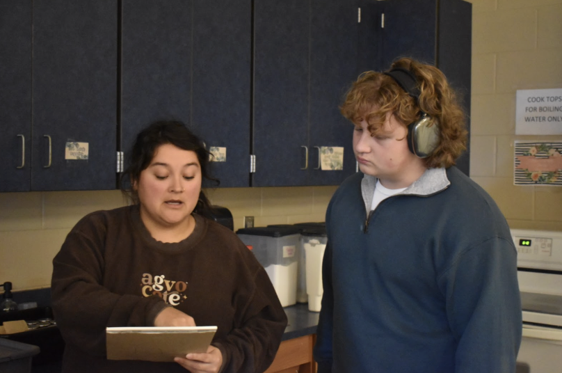 Explaining the instructions, Alicia Hampton, agriculture teacher, pulls out her list to help Madden Oswald, 12, figure out the motive. After different projects were dispersed, Hampton surveys and let the students take the wheel.